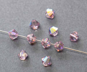 Кришталеві намистини Swarovski біконус 5328, 4мм Light Amethyst AB